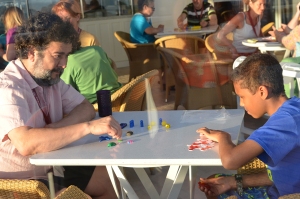 Jesús and the son of one of the conference attendees playing PORTL during the Five Go To Sea cruise.